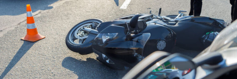 motorcycle flipped on its side beside traffic cone after an accident