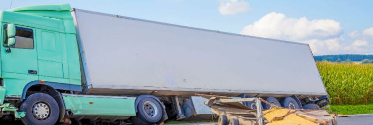 truck turned on its side on the side of the road