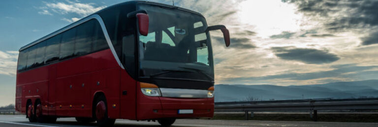 red bus driving down a highway