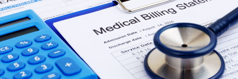 medical bills beside a calculator with stethoscope