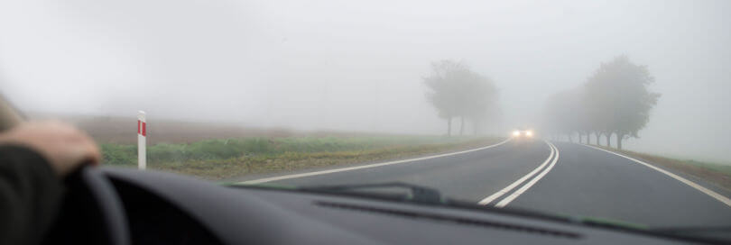 car driving on foggy road