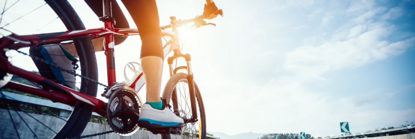 a picture from behind of a person riding their bike on the street