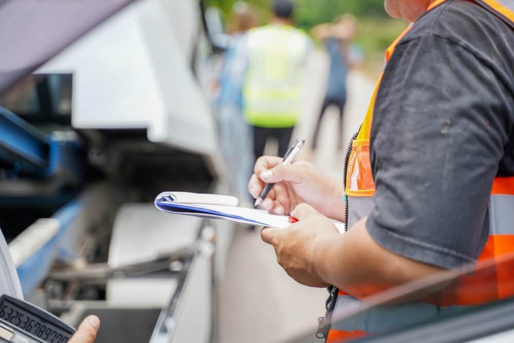 being assessed and processed on blurred damaged car truck slides and group of people background.