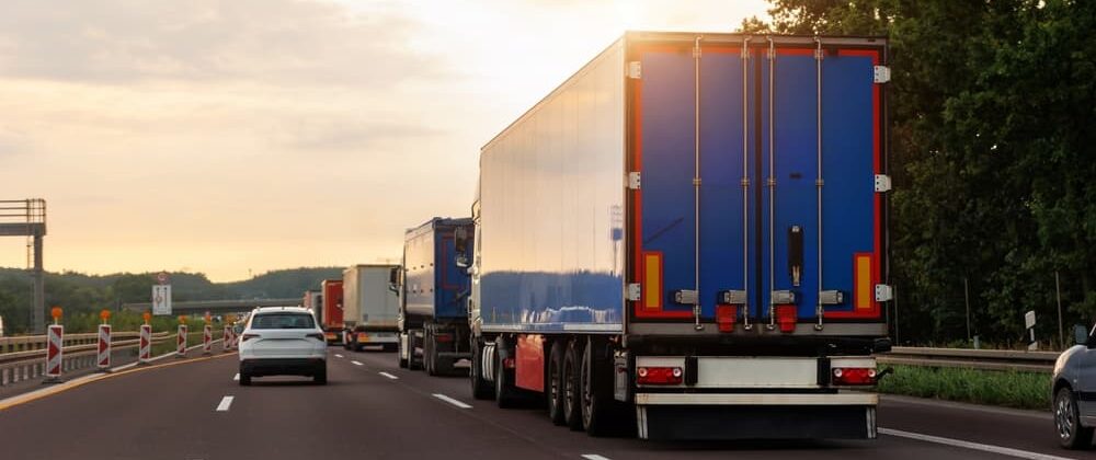 A truck driving on a highway alongside other cars, illustrating a sideswipe accident scenario.