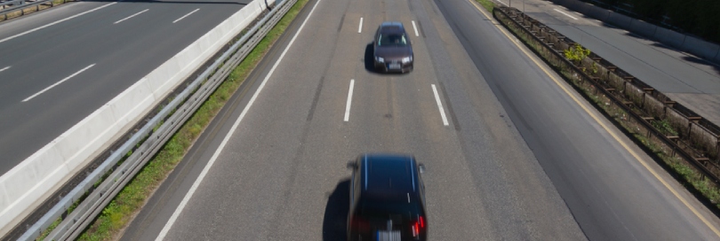 Cars speeding in the middle of the road