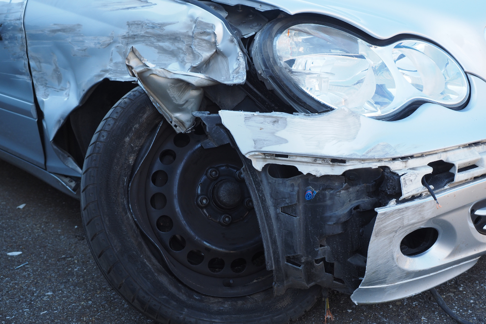 silver car with damage on the right fender